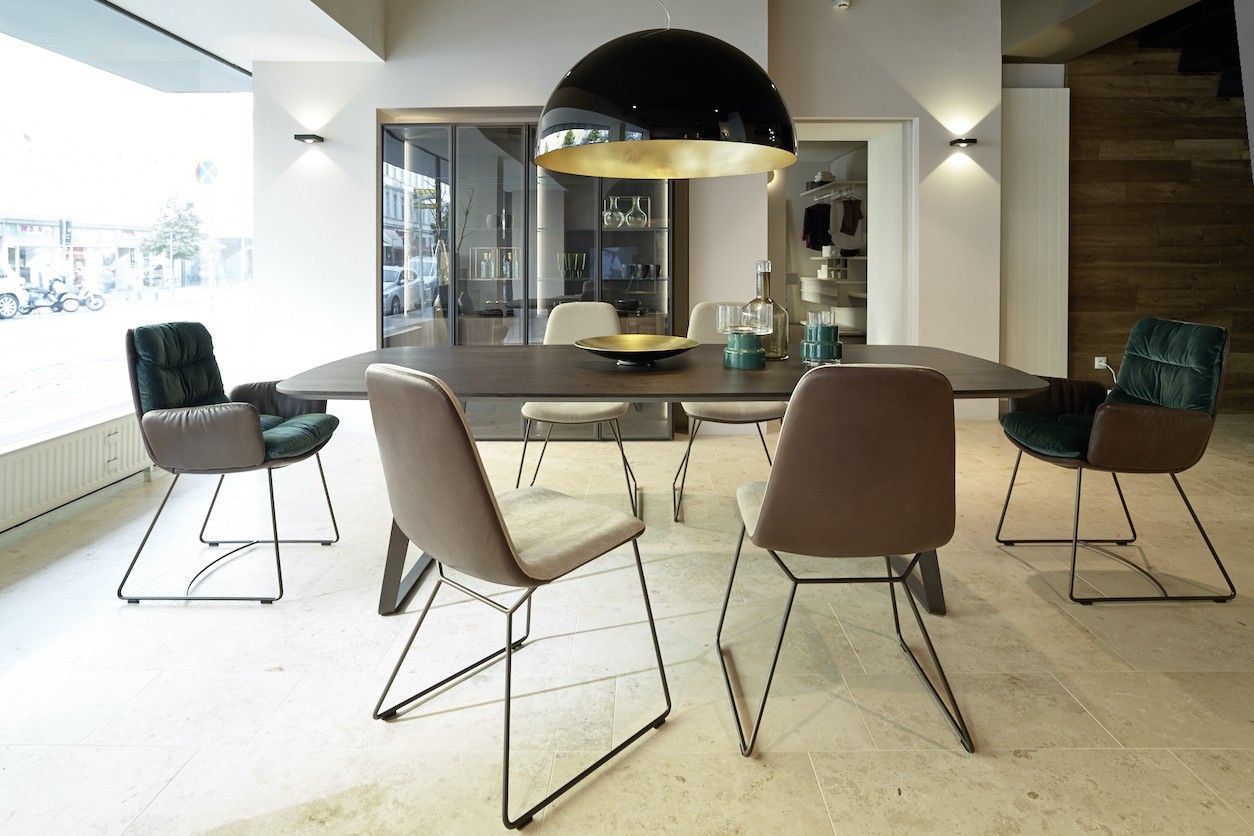 Foto: Verkaufsraum mit einem Tisch, Stühlen und einer großen Hängelampe